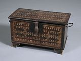 an old wooden box with a decorative design on the lid