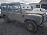 a grey land rover that is parked in a parking lot