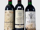 trois bouteilles de vin posées l'une à côté de l'autre sur une table