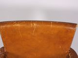 brown leather chair with a wooden seat and back rest