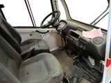 a truck that has a steering wheel and a seat in it