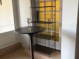 a small table with a shelf in the corner of the room
