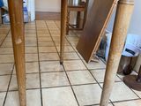 a wooden table with a drawer underneath it on a tiled floor