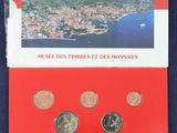 a red booklet with a picture of a city and mountains on it