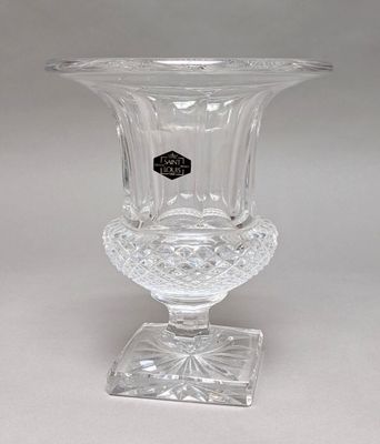 a clear glass vase with a black label on it