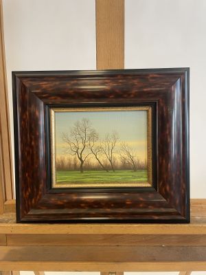 painting of a bare tree on a shelf in front of a white wall