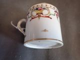 a coffee cup with a bird on it sitting on a table