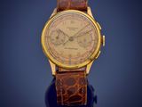 a close up of a gold wrist watch on a blue surface