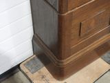 a wooden clock sitting on top of a piece of plywood floor