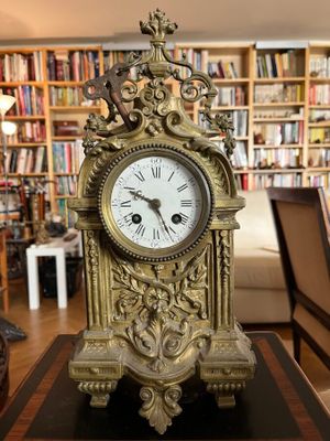 a clock that is sitting on a table in a library