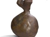 a brown vase that is sitting on a white surface