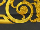 yellow and black fabric with a gold and black design on it