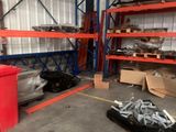 a red trash can in the middle of a large warehouse