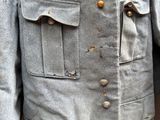 an image of a man ' s jacket with buttons on it