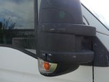 a side view mirror on the side of a white van