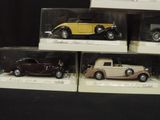 four different models of cars in a display case