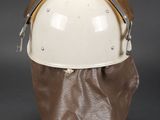 an image of a white helmet with a brown bag on a black background