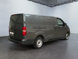 the van is parked in a large room with a black floor