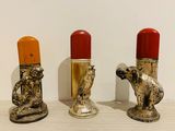 three lipstick holders that are sitting on a table