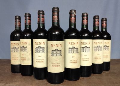 six bottles of wine are lined up in a row on a table