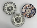 three plates with different designs on them on a white surface