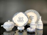 several pieces of blue and white china sitting on a table