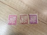 two stamps on a wooden table with a pink and purple stamp