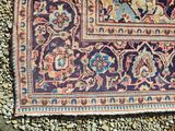 rug on the ground with rocks and gravel around it