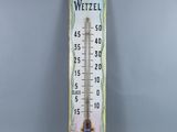 a close up of a thermometer on a gray background