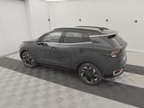 the rear end of a gray car parked in a garage