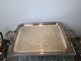 a silver tray sitting on a marble table next to a tea kettle