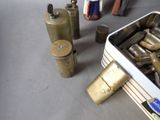 a metal box with a bunch of old brass items in it