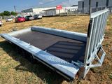 a flat bed trailer that is parked in the grass