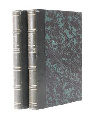 two books are stacked on top of each other on a white surface