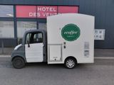 a small truck that is parked in front of a building