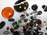 a lot of different colored stones on the table