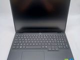 the laptop is open on a white surface with a black keyboard