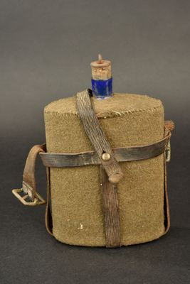a small bottle with a rope wrapped around it