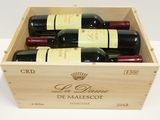 bottles of red wine in a wooden box on a table