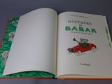 an open book with a picture of a mouse driving a car