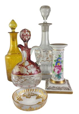 a group of glass vases and a plate on a table