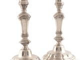 pair of silver candlesticks on a white background with a white background
