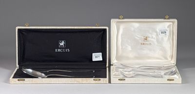 pair of silverware in a case with a spoon and spoon rest in it