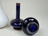two vases sitting next to each other on a table