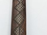 an image of a knife with a decorative design on it