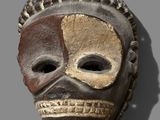an image of a wooden mask with a brown and white face