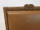 a picture of a brown leather chair with a gold frame