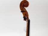 a close up of a violin on a stand against a white background