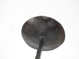 a large frying pan with a spoon in it