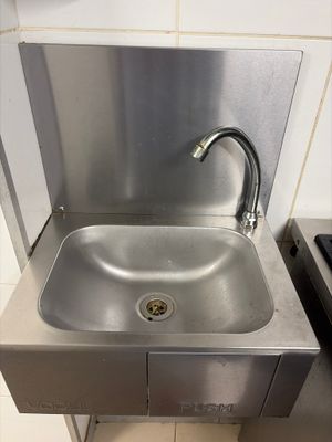 a stainless steel sink with a faucet in the corner